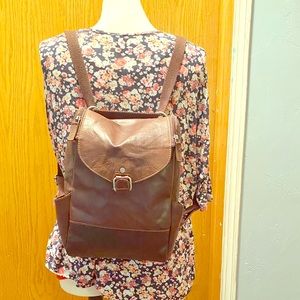 Jack George’s brown leather backpack
